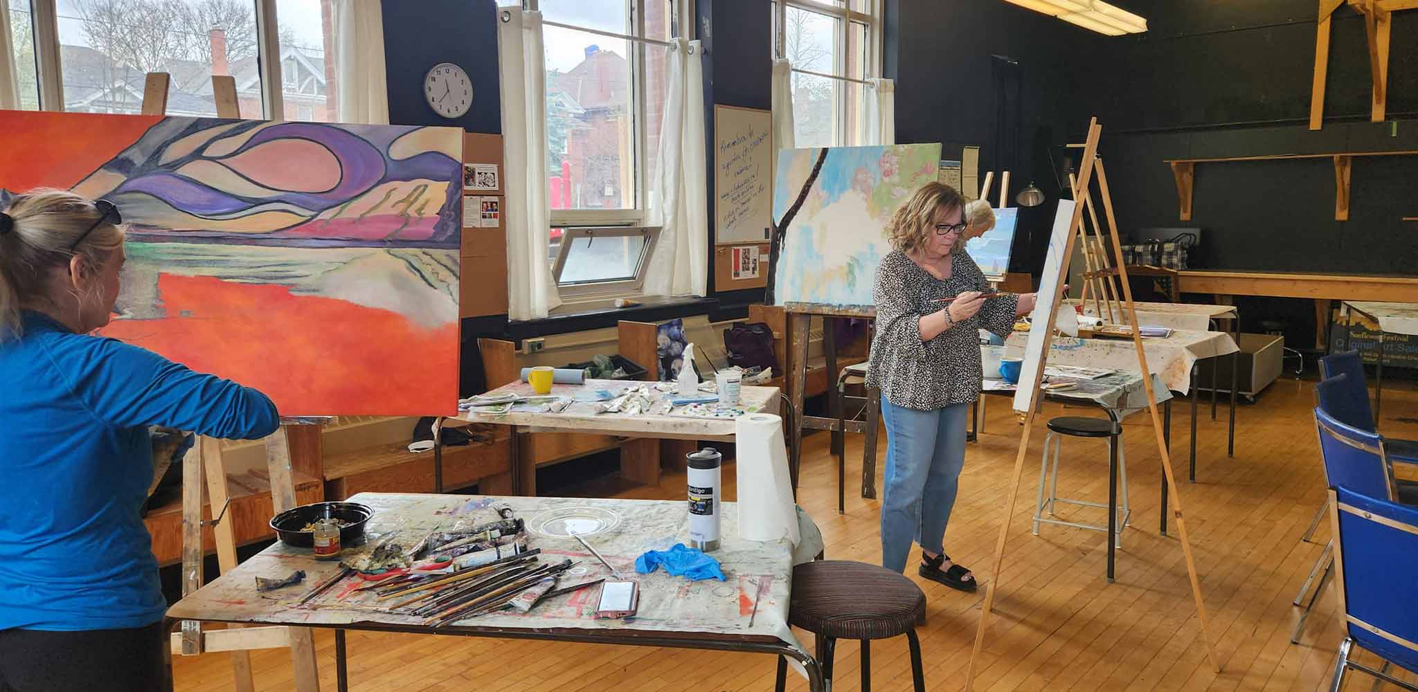 Studio 201 Artist Collective; a welcoming studio space featuring big windows for natural light, tall ceilings and hardwood floors.