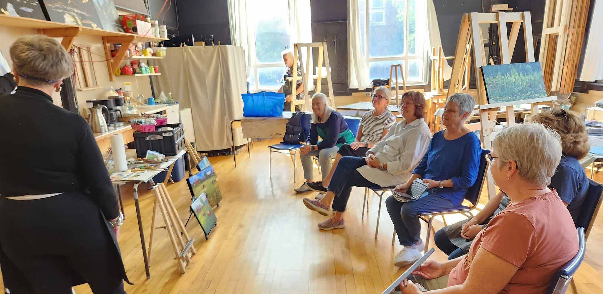 Studio 201 Artist Collective; a welcoming studio space featuring big windows for natural light, tall ceilings and hardwood floors.